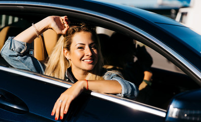 Image of side view of happy girl sitting in car