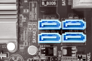 Blue color 4x SATA-II port in  desktop PC motherboard on black and white color filter, SATA-II is a port for hard disk connectivity, close-up and selective focus by macro lens