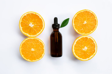 Essential oil with orange slices isolated on white