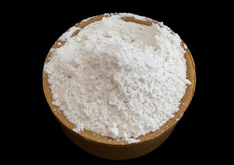 flour in a bowl with black background