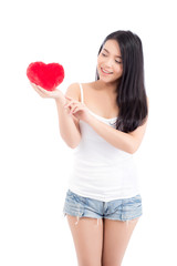 Portrait of beautiful asian young woman holding and pointing red heart shape pillow and smile isolated on white background, valentines day, holiday concept.