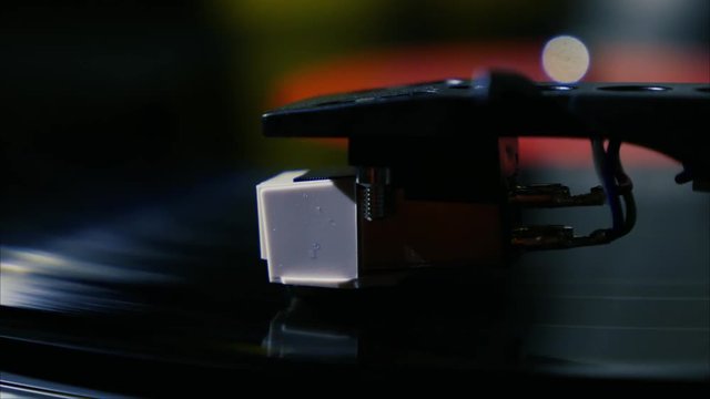 Closeup needle on spinning vintage vinyl record on turntable