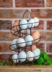 Real free range eggs showing wide range of colours and sizes from different breeds of chickens,...