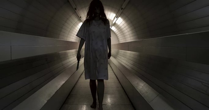 Scary zombie coming to the camera with knife