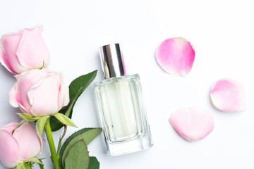 Obraz na płótnie Canvas Perfume bottles and rose on white background