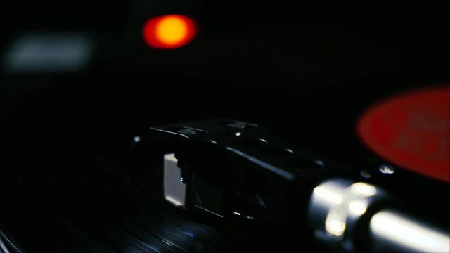 Closeup needle on spinning vintage vinyl record on turntable