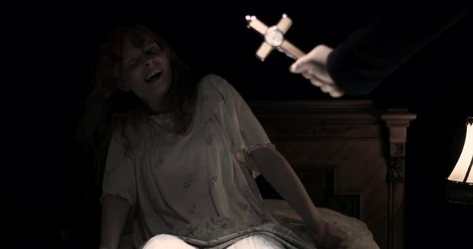 the priest with the cross do an exorcism the obsessed girl