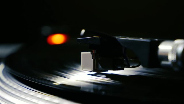 Closeup needle on spinning vintage vinyl record on turntable