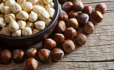 Hazelnuts, filbert  in bowl on wooden table. heap or stack of hazelnuts. Hazelnut background,...