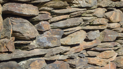 old wall made of stones in autumn sunshine, no people