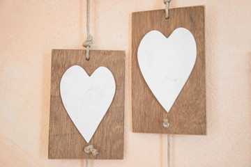 White wooden heart with pink bacground