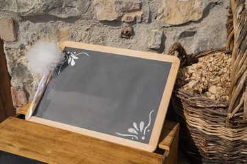 Empty blackboard on stone wall