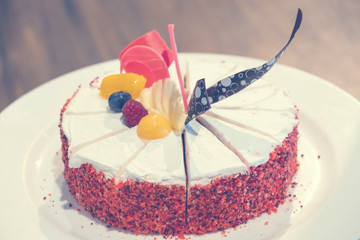 Homemade vanilla birthday cake decorated with blueberries, raspberries,mango.