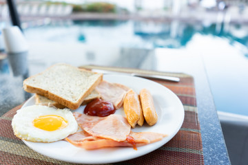 Delicious Breakfast set by the swimming pool at Pattaya, Thailand