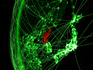 North Korea from space on green model of Earth with international networks. Concept of green communication or travel.