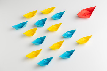 Influencer, KOL, key opinion leader or leadership concept, big red origami paper ship leads in...
