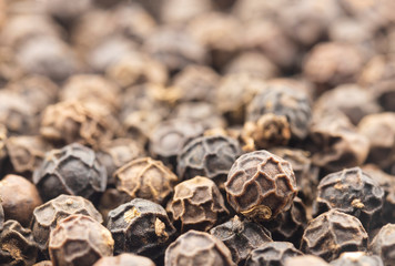 close up of black peppercorns for white background