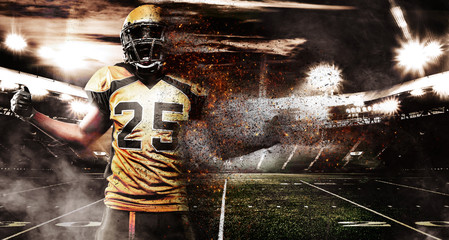 American football player, athlete in helmet on stadium in fire. Sport wallpaper with copyspace on background. © Mike Orlov