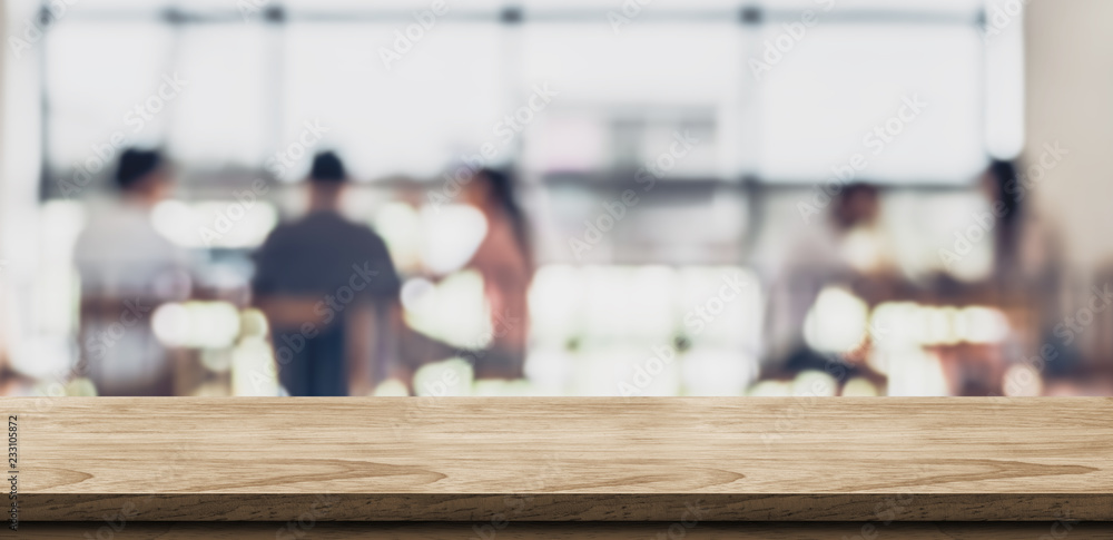 Aufkleber empty wood table with blur people in coffee shop background bokeh light and leaf foreground,mock up 