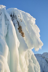 Icicles hang from the rocks. Lake Baikal is a frosty winter day.