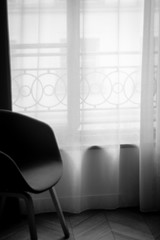 Artistic image of window with transparent curtains in monochrome - interior of Paris apartment