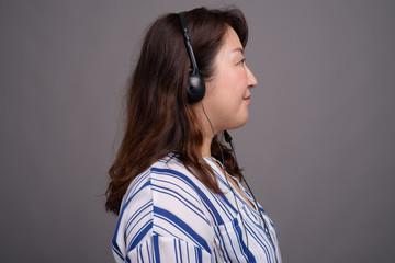 Portrait of mature Asian call center representative businesswoman