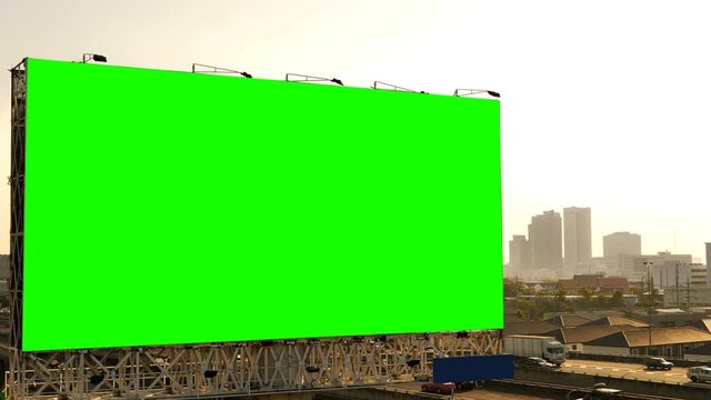Green screen of advertising billboard on expressway during the sunset with city background in Bangkok, Thailand...