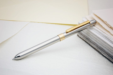 a silver pen on paper