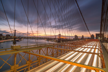 View on Brooklyn bridge driveway and east river with Manhattan bridge at sunrise ,long exposure photo