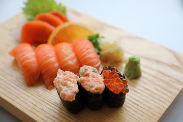 Salmon sushi and sashimi on wood plate Japanese food