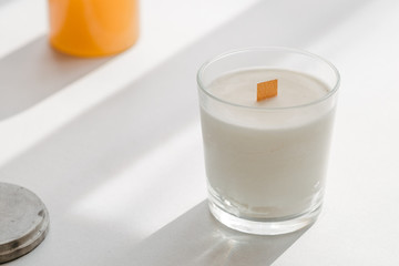 Organic scented soy candle on white. Loft interior decor, minimalism concept.  Closeup, copy space for text