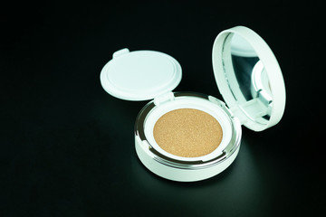 Beauty foundation cushion with sponge on black background