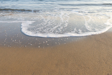 good background image of a sandy beach and white sea foam, a good choice for creating a collage