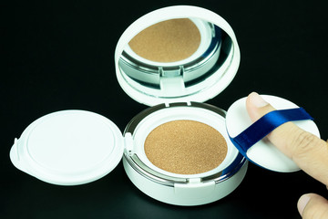 Beauty foundation cushion with sponge on black background