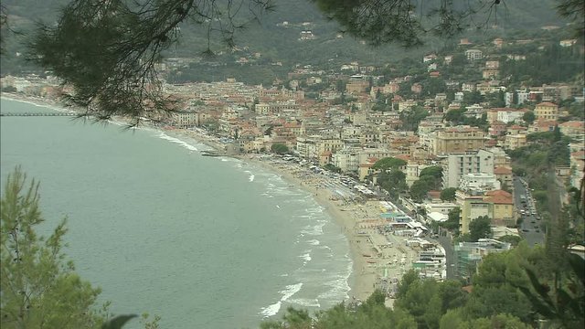 Long shot of a seaview of the coast and city of Badalucco along the Riviera in Italy