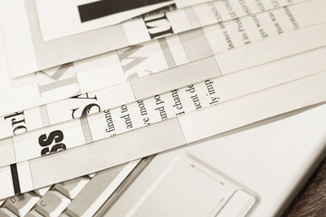 Folded newspapers with headlines and articles on keyboard of laptop. Modern technology replacing old fashioned paper journals and magazines, since internet is more fast way to get news and information