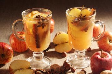 Two cups with hot cider in cold season with cinnamon and anise