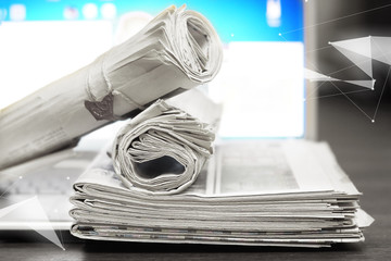 Newspapers and computer. Laptop and daily papers on the table. Fresh news by  paper or by...