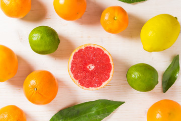 Tropical citrus fruits on rustic wooden background