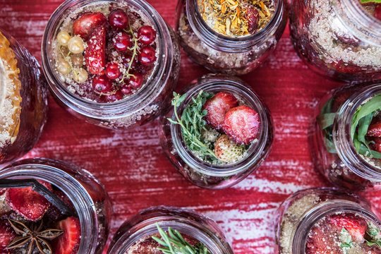 Overhead view of spiced strawberries in jars