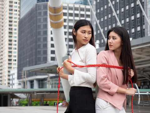 business people pull rope for fight together