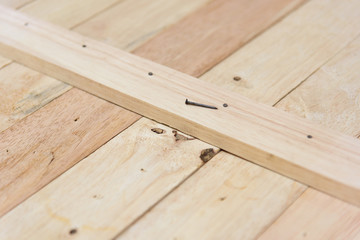 Worker hammer the nail into the wood