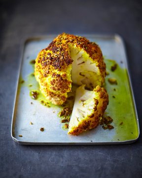 Roasted cauliflower seasoned with turmeric powder and aniseeds (sliced)