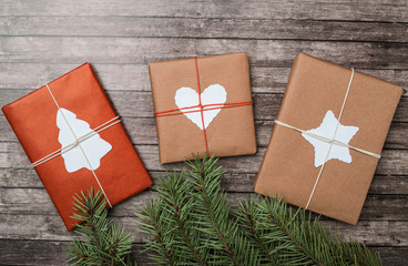 Christmas gifts with fir-tree on wooden background.