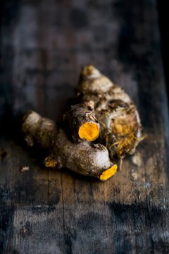 Turmeric roots on a wooden surface