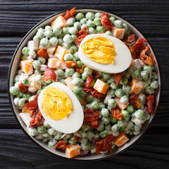 English Pea Salad is a hearty side dish with eggs, bacon, minced red onion, and cheddar cheese all blended together with a creamy dressing. top view