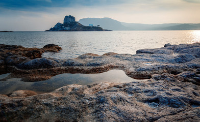 Kos island, Greece, coast view of Kefalos village, island of Kastri and an orthodox temple at sunset