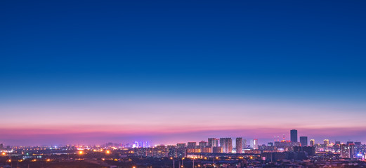 a city far away from the road after the sun sets in the evening