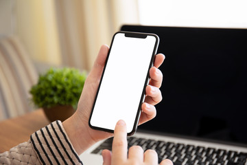 female hands holding touch phone with isolated screen in office