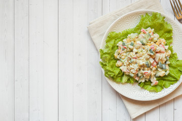 Obraz na płótnie Canvas Salad with crab sticks, sweet corn, cucumber, eggs and mayonnaise on light table